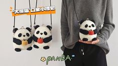 a person holding three panda keychains in their hands and hanging them from strings