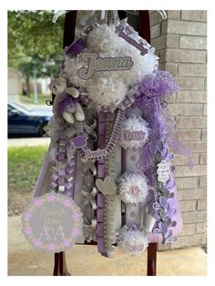 a purple and white dress made out of hair clips with personalized name on it