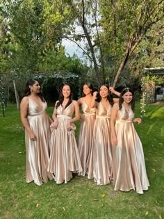 the bridesmaids are posing for a photo in their dresses