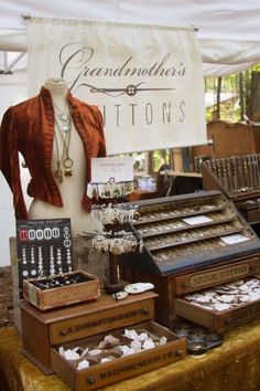 an old fashion store display with jewelry and necklaces on it's stand in front of a sign that says grandmother's buttons