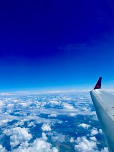 the wing of an airplane flying high above the clouds