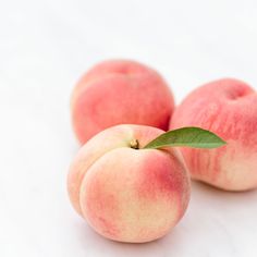 three peaches sitting on top of each other