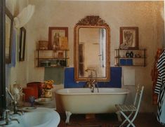 an old fashioned bathtub in front of a large mirror