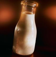 a glass bottle filled with liquid sitting on top of a table