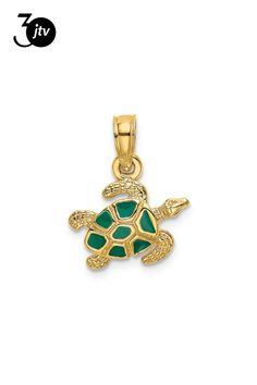 a gold turtle pendant with green stones