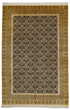 an antique rug with black and gold designs on it, in the middle of a white background