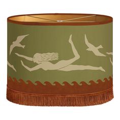 a lampshade with an image of a woman on the water and birds flying around it