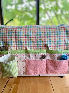 the sewing bag is sitting on the table next to it's storage pockets