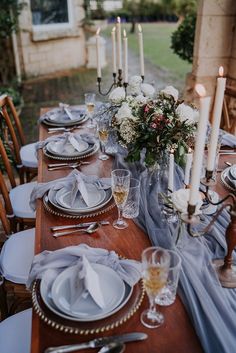 the table is set with candles and plates