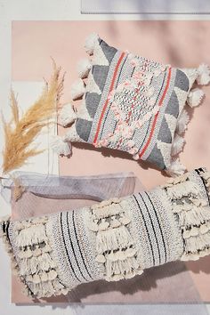 two pillows, one with tassels and the other with fringe