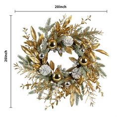 a christmas wreath with gold and silver decorations on it's side, next to a ruler