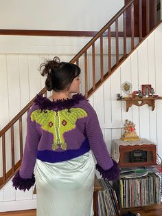 "Penny Lane Luna Magic Sweater with a tie  Step into the world of bohemian style with this beautiful handmade crochet Luna Moth Penny Lane Sweater 🦋 in purple and green hippie style! 🌿🌸 Crafted with love and care, this stunning sweater is designed to be both stylish and comfortable. The intricate crochet pattern creates a beautiful luna moth design that adds a touch of whimsy to the overall look. The purple and green color palette is perfect for those who love to experiment with bold and vibrant colors. 💜💚 The Penny Lane style is a classic bohemian silhouette that features long, flowing sleeves and a relaxed fit, making it perfect for layering over your favorite maxi dress or pair of bell bottoms. The sweater is handmade with high-quality yarn to ensure a durable and long-lasting piec Whimsical Knitting, Trippy Crochet, Purple And Green Color Palette, Whimsy Crochet, Luna Moth Design, Maximalist Fashion Style, Whimsical Crochet, Moth Design, Hippie Sweaters