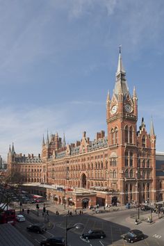 a large building with a clock on it's face in the middle of a city