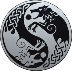 a black and white yin yang symbol with an intricate design on the front of it