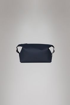 Hilo Wash Bag is a waterproof toiletry bag designed to hold daily wash and grooming items when traveling. The waterproof design is characterized by its minimal silhouette, yet large main compartment accented by side-mounted buckles. The buckles can be adjusted to compress the design and keep contents in place, while helping to make the best use of luggage space. Hilo Wash Bag features plenty of room for daily wash and grooming items, cosmetics and smaller personal essentials. Hilo Wash Bag is de Pu Fabric, Wash Bag, Grey Wood, Navy And Green, Wash Bags, Weekender Bag, Small Designs, Bago, Toiletry Bag