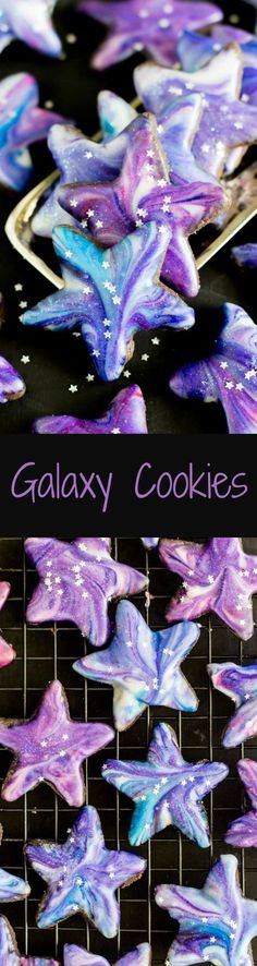 galaxy cookies with purple and blue icing are on a cooling rack in front of a black background