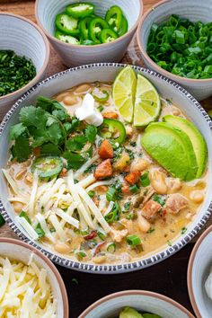 several bowls filled with different types of food and garnished with cilantro