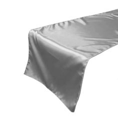 a silver satin table runner on a white background