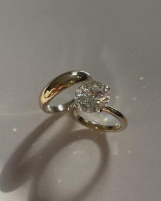 a diamond ring sitting on top of a table