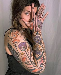 a woman with tattoos covering her face and hands