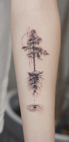 a tattoo with trees and water on the leg