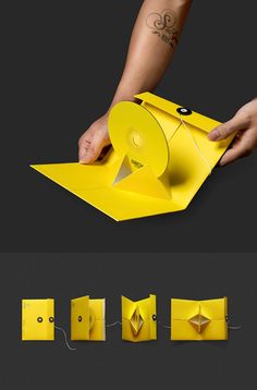 an origami box is being held by someone's hand and it has the lid open