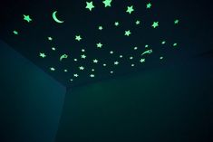 glow in the dark room with stars and moon wall decals on the ceiling,