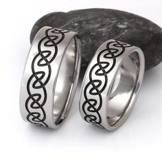 two wedding rings with celtic designs on them