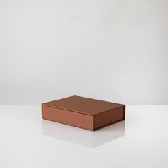 a brown box sitting on top of a white table