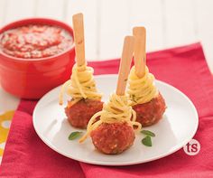 spaghetti and meatballs on skewers with dipping sauce