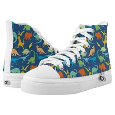 Colorful Dinosaur silhouette pattern. Tyrannosaurus Rex, titanosaurs, Triceratop, raptors, Ankylosaurs, Dino-Birds, Stegosaurus, Apatosaurus, Pteranodon and more in a colorful pattern in blue background, and dinosaurs in green, blue, yellow and orange. Sneaker Gift Ideas, Sneakers Colorful, Dinosaur Shoes, High Top Tennis Shoes, Colorful Dinosaur, Dinosaur Silhouette, Printed Shoes, Hightop Sneakers, Dinosaur Pattern