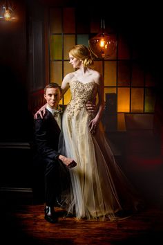 a man and woman in formal wear posing for a photo