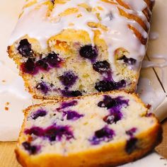 a loaf of blueberry bread sitting on top of a cutting board