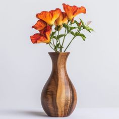 a wooden vase filled with orange flowers on top of a table