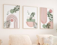 three paintings hang on the wall above a couch