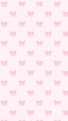 a pink wallpaper with small bows on it