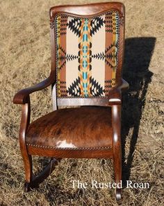 an old wooden chair sitting on top of dry grass