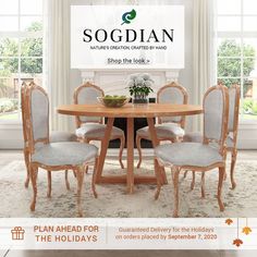 a dining room table with four chairs and a chandelier above it in front of a fireplace