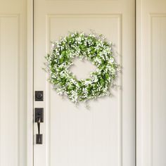 a white door with a wreath on it