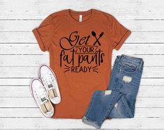 Get Your Fat Pants Ready Shirt Bella Canvas Unisex T-Shirt. These shirts are a soft, jersey unisex fit. Perfect for a side knot, tucked in with a belt, rolled up sleeves or worn just to lounge. Choose your size and shirt color. Processing time is up to 10 days before it ships so please let me know before you order if you need it sooner. An extra charge may apply for faster shipping. If you do not see your size or color option, please message me for possible options Care Instructions: Turn shirt Feast Mode Shirt, Womens Football Shirts, Fat Pants, Funny Thanksgiving Shirts, Fall Shirts Women, Scary Halloween Party, Autumn Clothes, Pumpkin Shirt