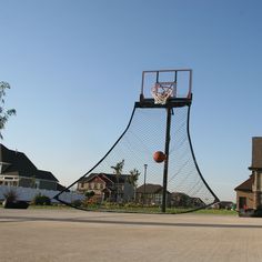 an outdoor basketball court in the middle of a neighborhood