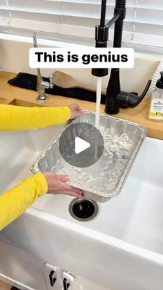 a woman washing dishes in a sink with the words this is genius on top of it