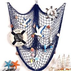 there is a wall hanging with seagulls and seashells on the net