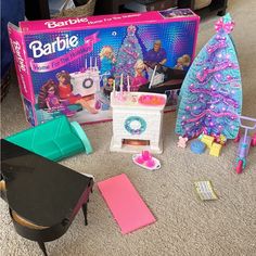 barbie's christmas tree and other toys on the floor