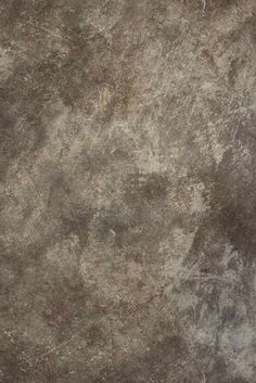 an old, grungy concrete wall textured with dark brown stains and scratches