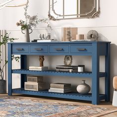 a blue console table with two drawers on top and a mirror above it in a living room