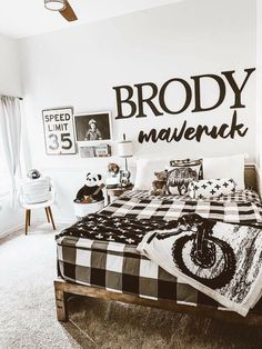 a bed room with a neatly made bed and pictures on the wall