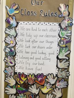 a classroom door decorated with handprints and writing that says, our class rules we are kind to each other