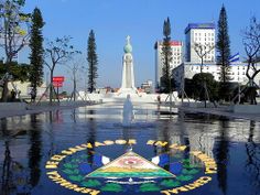 the monument is surrounded by trees and buildings