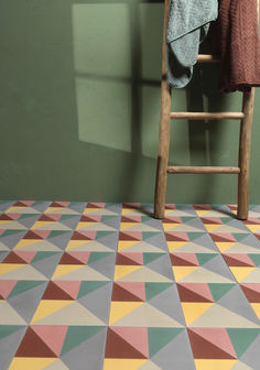 a wooden chair sitting on top of a colorful floor